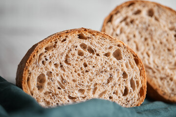The process of making wheat bread at home. A slice of homemade sourdough bread. The concept of healthy homemade food. Front view.