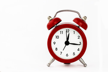 Red retro alarm clock on a white background.