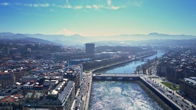 unique fly by drone shot over Urumea river and the old town of San Sebasti&aacute;n we see the buildings with the Kursaal art gallery the wonders of the sea in background during a lovely sunny day