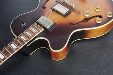 Jazz electric guitar on a dark background. Close up. - obrazy, fototapety, plakaty