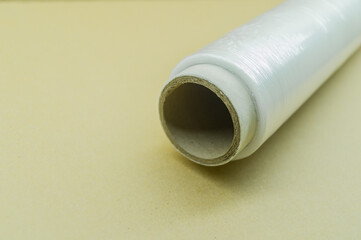 Roll of wrapping plastic stretch film. Packaging film in a roll on a cardboard spool. Selective focus