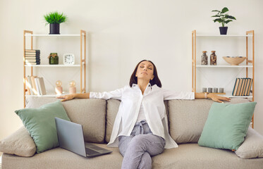 Relaxed woman resting on soft comfy couch at home, breathing deeply, enjoying peace, quiet and...