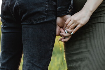 Horizontal close-up photo of a couple holding hands