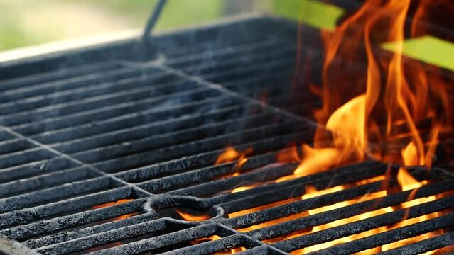 Close-up barbecue grill, slow motion night burning fire flame, cooking outdoors