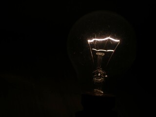 The close up shot of a lighting filament bulb
