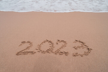 New year 2023 is coming with sunset beach background. New start for planing or set new resolution in life.