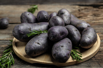 Raw sweet potatoes on wooden background closeup. Batata potato. vegan food ingredient. banner, menu, recipe place for text, top view