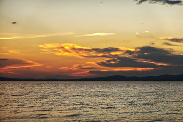 Dramatic sunset sky with clouds above sea