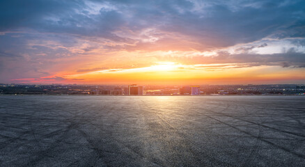 Empty asphalt road and modern city skyline with building scenery at sunset. high angle view.