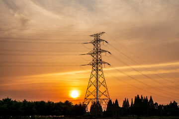High voltage electric tower at sunset. Transmission power line. Electricity pylons and sky clouds...