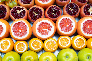 Texture of different juicy fruits with cut top
