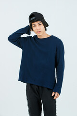 Portrait isolated cutout studio shot Asian young handsome slim teenager fashion male model in long sleeve shirt standing posing smiling holding hand adjusting black baseball cap on white background