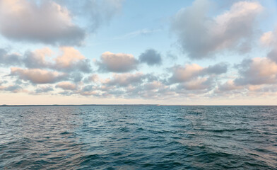 Panoramic view from the Baltic sea shore after the storm. Clear sunset sky, reflections, still...
