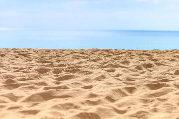 Closeup sandy beach with sea background, Tropical summer beach background, outdoor day light, empty clean fine sandy beach
