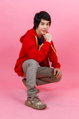 Portrait full body studio shot of Asian young urban teenager fashion male model in street style...