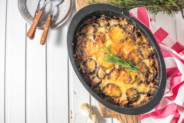 Mousaka with aubergine dish on rustic wooden table close up