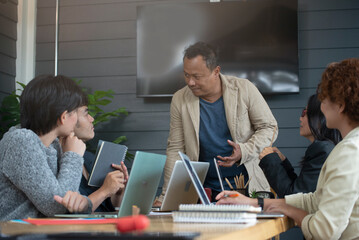 Group of business people plan annual budget report and work to solution strategy during brainstorming meeting. Collaborate of Professional Businessman and team at office. Strategy Business concept.