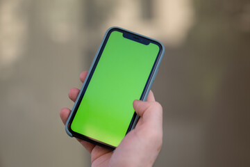 Businessman with Green Screen Chroma Key Smartphone in Office.  Businessperson using Internet, Social Media, Online Shopping with Mobile Phone Device. Over Shoulder picture