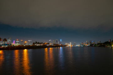 Miami city. Miami skyline panorama at dusk with skyscrapers over sea. Night downtown sanset.