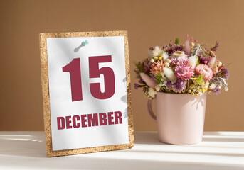 december 15. 15th day of month, calendar date.Bouquet of dead wood in pink mug on desktop.Cork board with calendar sheet on white-beige background. Concept of day of year, time planner, winter month