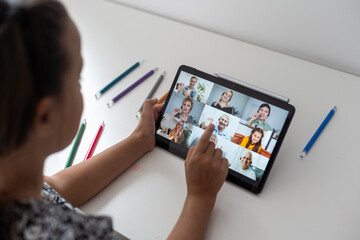 Closeup view of little girl using tablet for conversation video chat at home