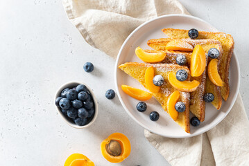 Traditional french toasts with cinnamon, blueberries and apricots. Healthy breakfast recipe....
