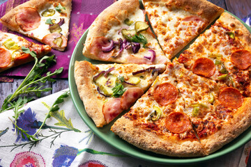 Slices of Chorizo Pizza and Bacon Pizza with Pickled Cucumbers and Onion.