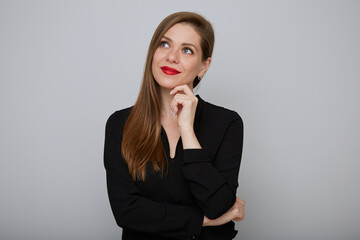 Smiling business woman in black shirt thinking and looking up,  isolated portrait