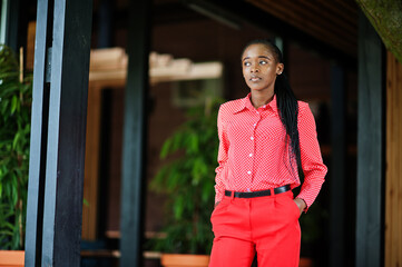 Pretty braids business african american lady bright bossy person friendly wear office red shirt and trousers.