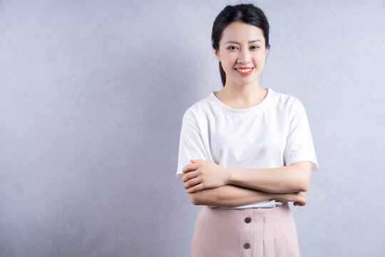 Imagr of young Asian woman posing on background