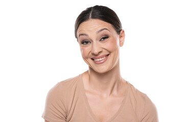 Young caucasian woman looking with fake smile at camera with doubt and distrust