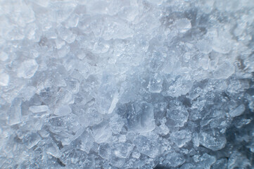 Close-up of crystals of dark sea iodized salt. Extreme macro background minerals salt