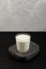 Ayran or Kefir on grey background. Vertical orientation. Fermented sour milk. Buttermilk made with yogurt. Milk diet for weight loss
