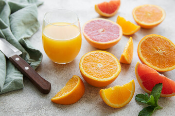 Glasses of juice and citrus fruits