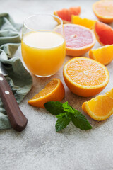 Glasses of juice and citrus fruits