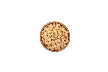 Delicious Cedar nuts in wooden bowl on white background, top view.  Peeled Pine kernel nuts. Design...