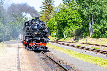 Old steam locomotive on narrow-gauge railwaytrack