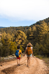 Obraz premium A child with mom walks along a forest path