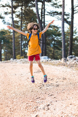 The child is jumping, summer holidays in nature