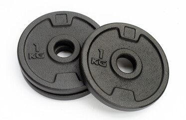 Black weight plates on white background. Gym equipment