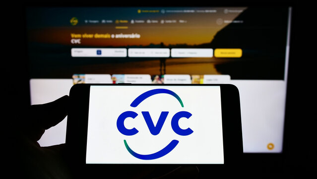 Stuttgart, Germany - 06-25-2022: Person holding mobile phone with logo of company CVC Brasil Operadora e Agencia de Viagens S.A. on screen with web page. Focus on phone display.
