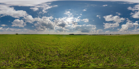full seamless 360 hdri panorama view among farming fields with sun and clouds in overcast sky in...