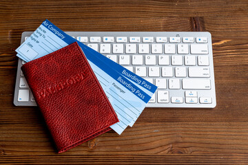 Fototapeta premium Booking air tickets concept. Passport with computer top view