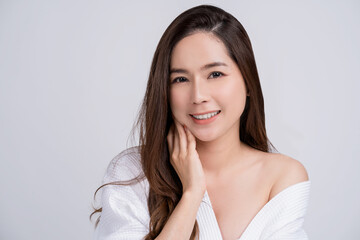Fototapeta premium Beautiful smiling asian women portrait with clean fresh skinon white background. Face care, Facial treatment, Cosmetology, beauty and spa