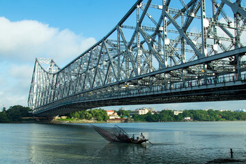 iconic Howrah bridge or Rabindra Setu  of Kolkata and boat in river Ganges 