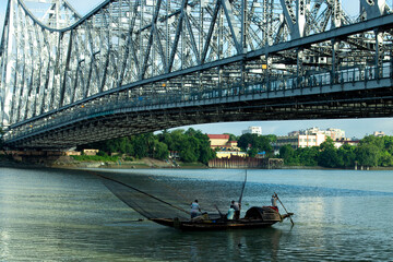 iconic Howrah bridge or Rabindra Setu  of Kolkata and boat in river Ganges 