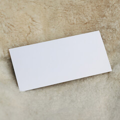 White paper card lies on a fur background