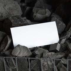 White card on black sauna stones