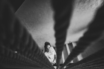 Perfect fashion bride in luxury wedding dress on stairs. Black and white photo.