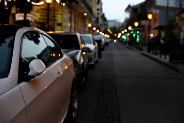 City street with parked cars in evening